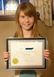 Students receive a reading certificate when they graduate. Reading Student with Graduation certificate